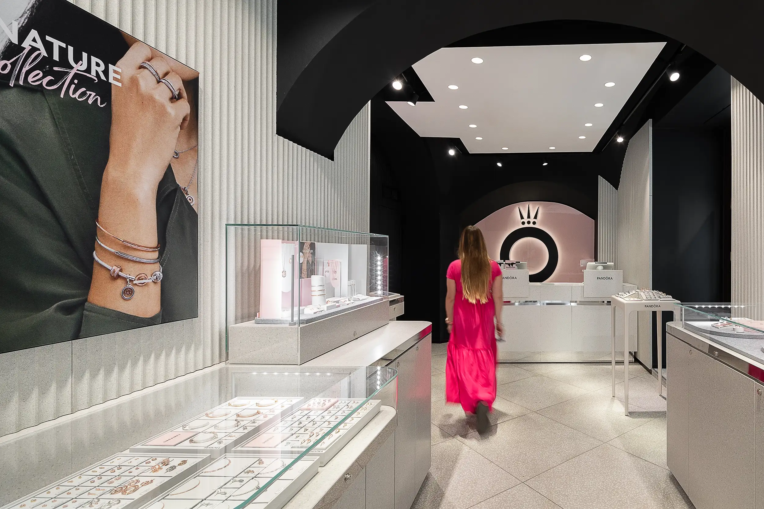 The Interior of Pandora jewelry store at Prague Wenceslas Square, together with shopkeepers walking through the store, blurred in motion.