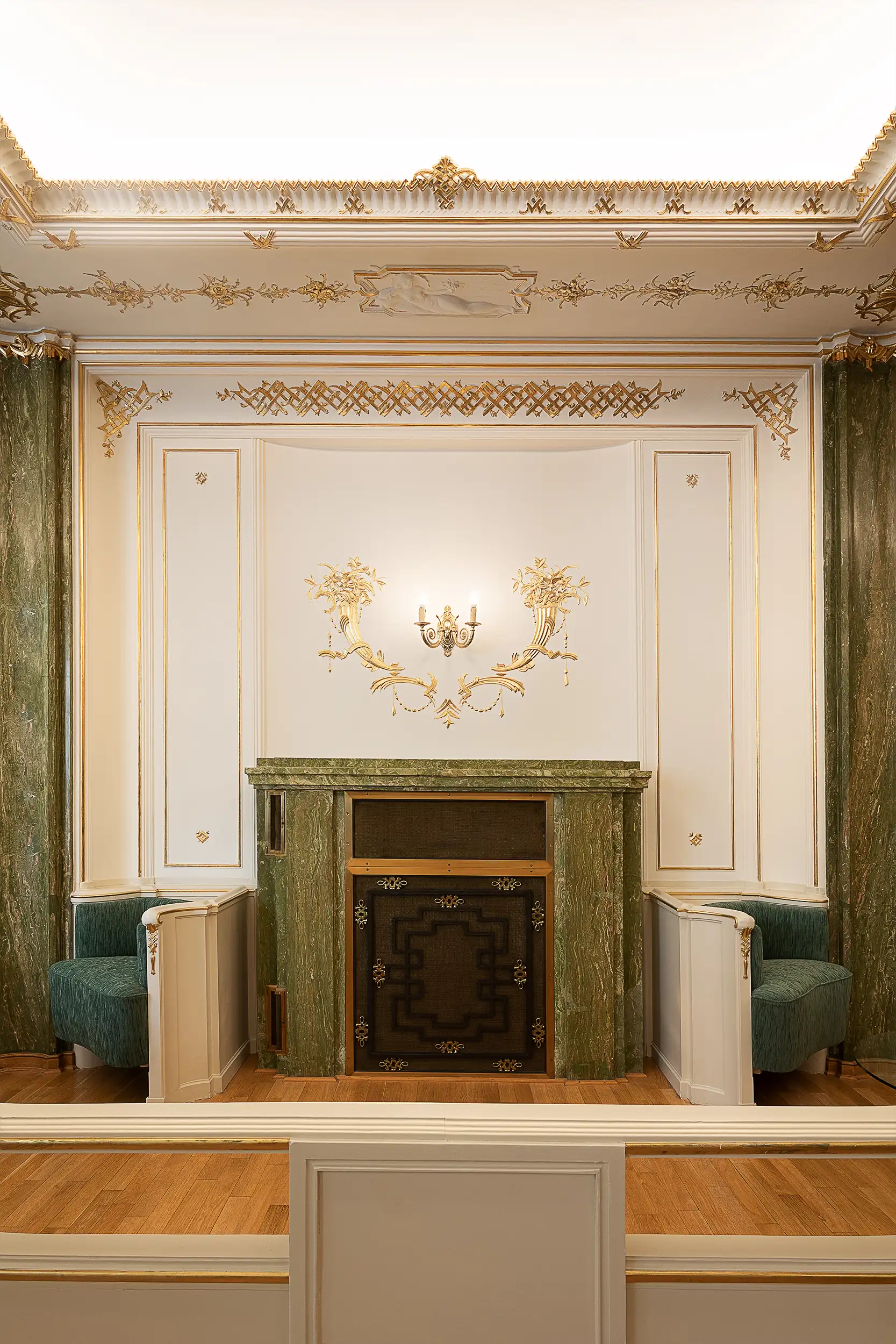 Raiffeisenbank's offices at Palace Astra on Wenceslas Square in Prague, Czech Republic, feature a green and cream-toned secession interior with a fireplace.