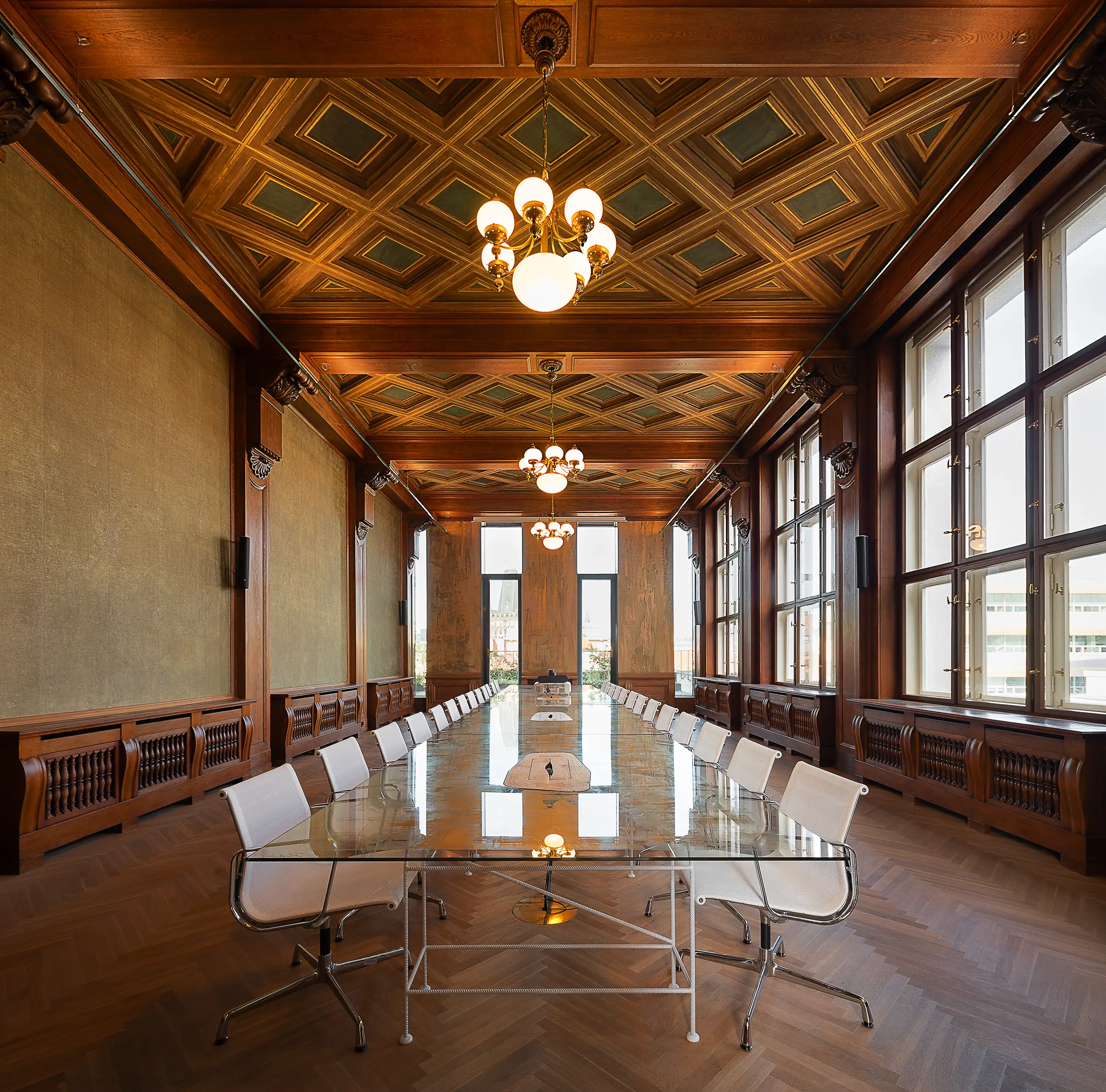 The meeting room of the Denton law office is located in the historic palace Špork in Prague, Czech Republic. The interior is adorned with wooden decor and has a high ceiling.