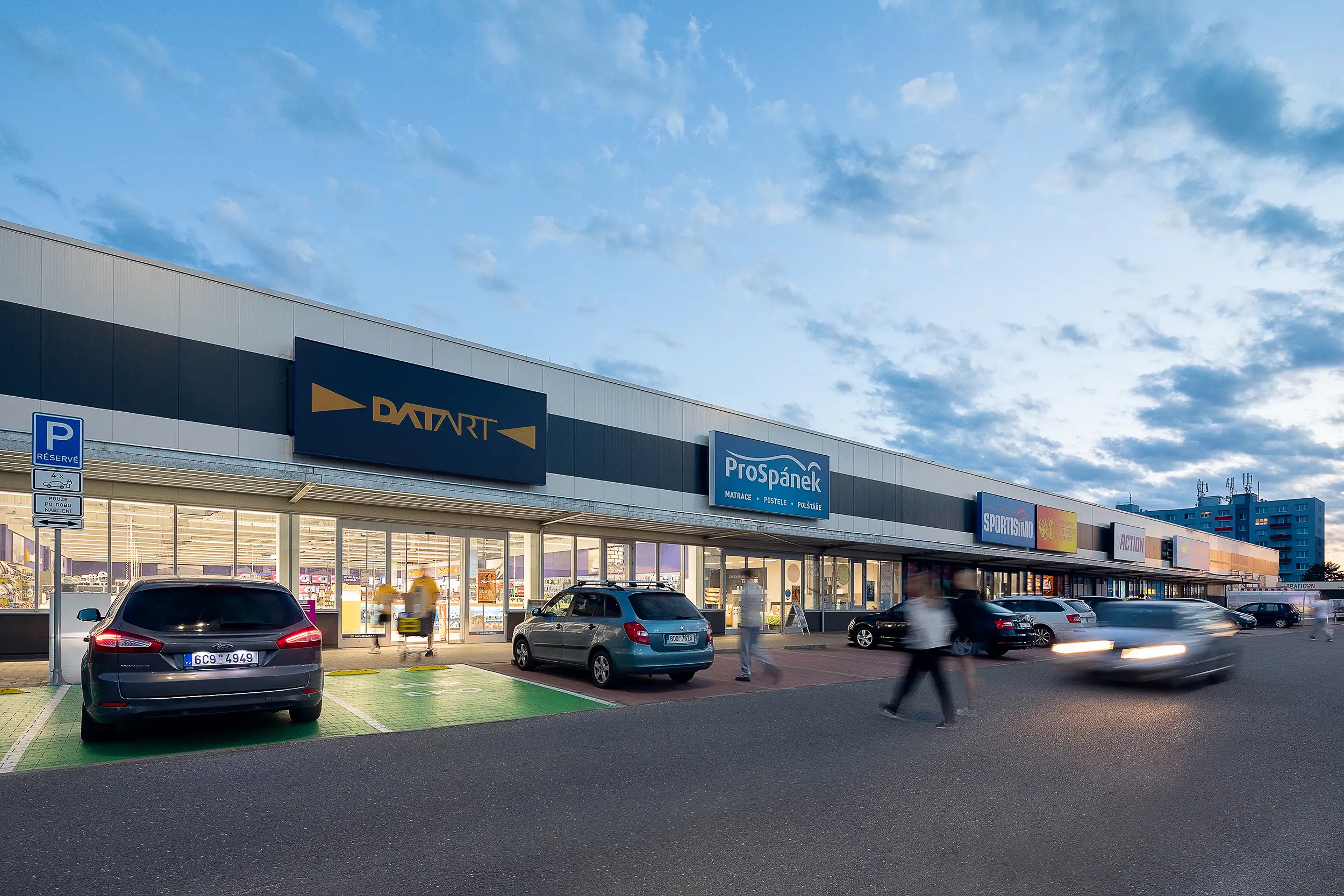 An example of a retail park photographed at dusk, featuring a commercial space in Tabor.