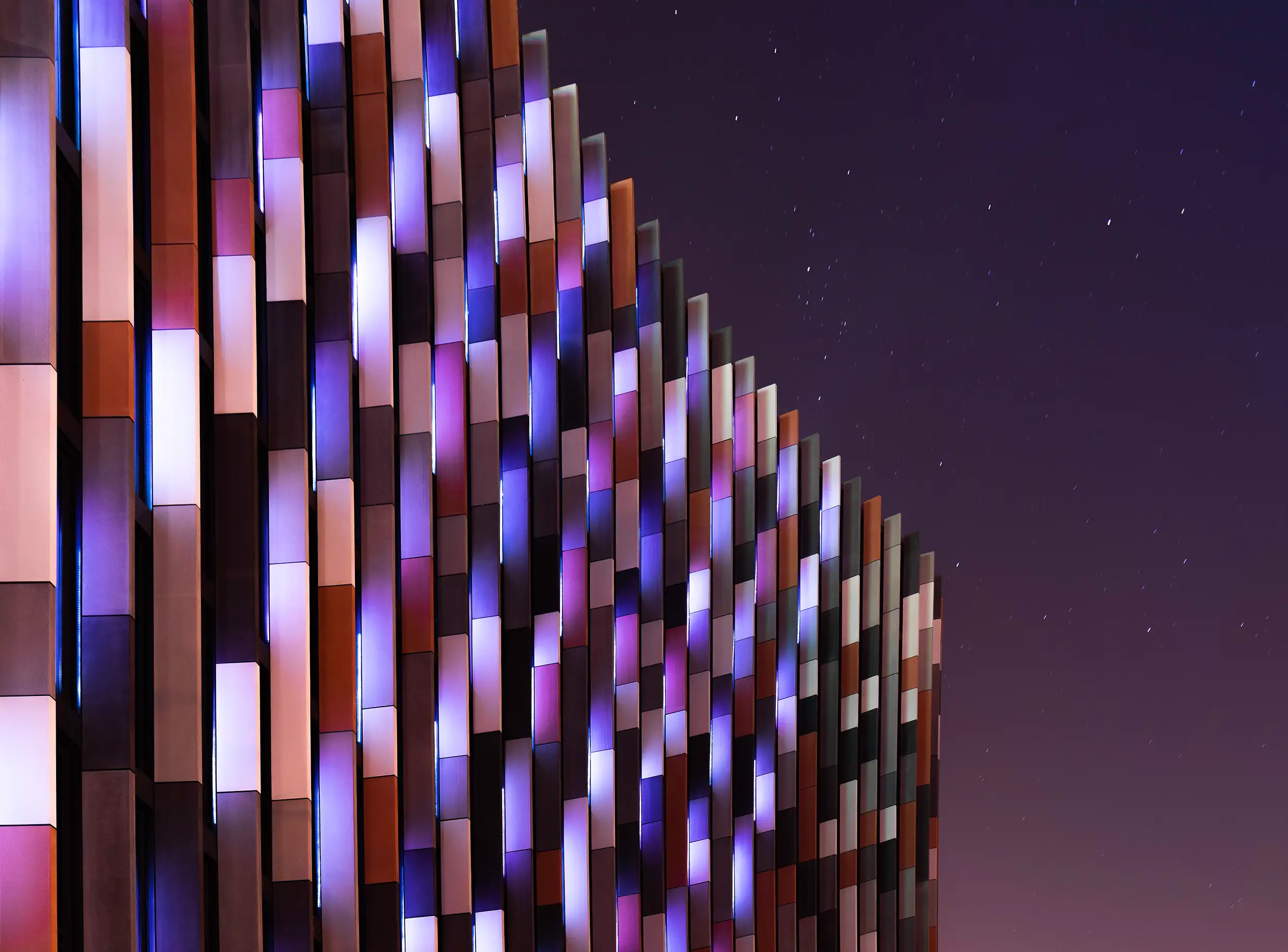 Coloured exterior wall panels of Main Point building captured during the night. A modern facade captured by professional architectural photographer Ondrej Hromadko.