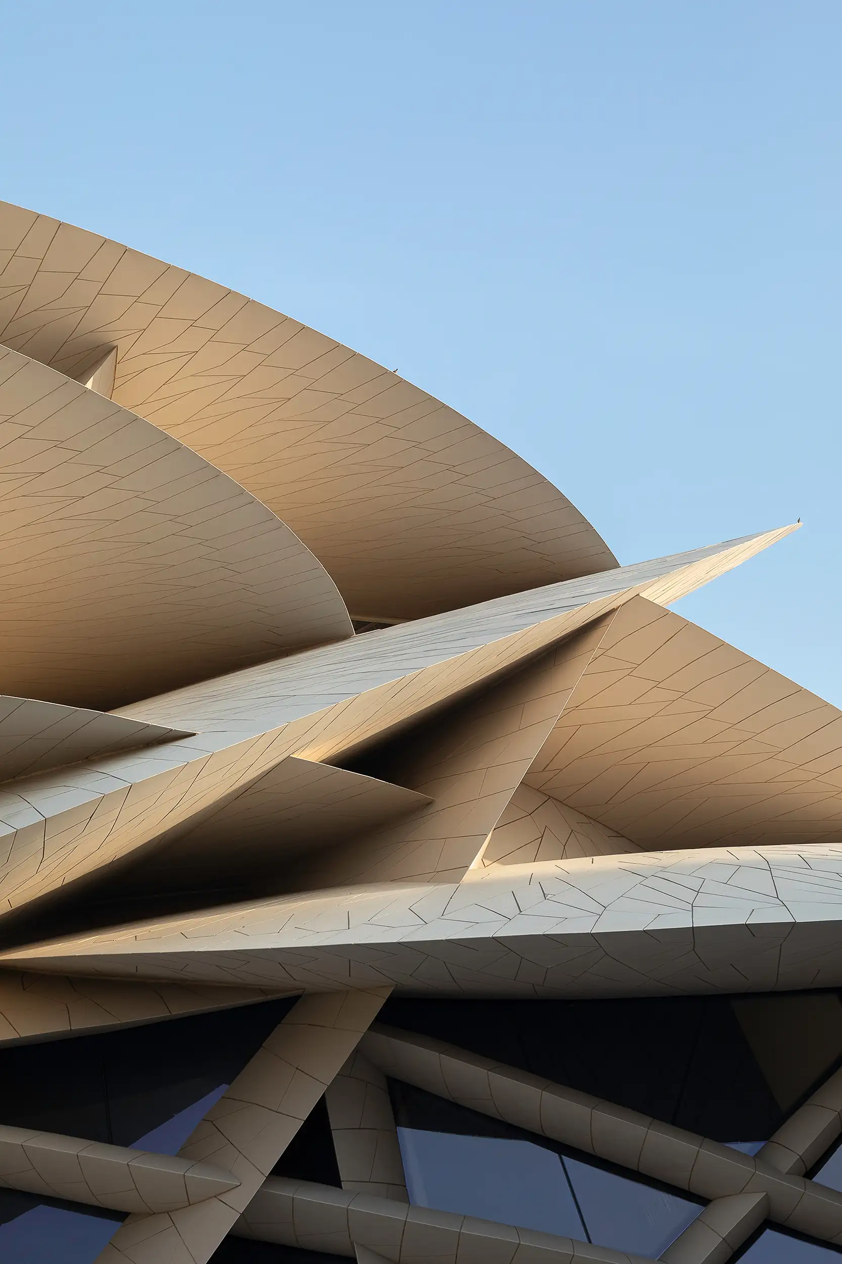 abstract detail of the tangle of lines of intersecting discs and windows on the façade of the Doha National Museum.