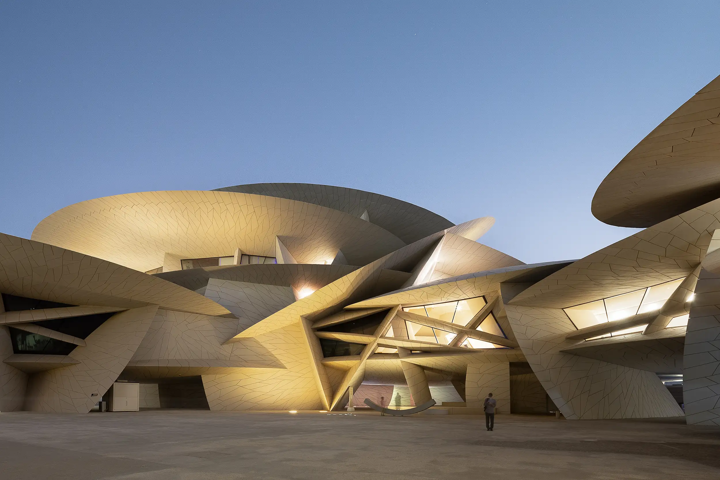 The courtyard of the National Museum of Qatar in Doha, captured at dusk by architectural photographer Ondrej Hromadko.