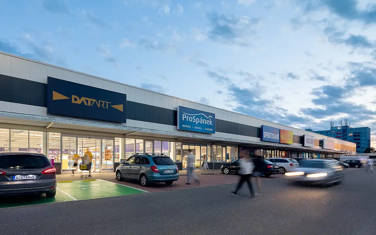 An example of a retail park photographed at dusk, featuring a commercial space in Tabor.