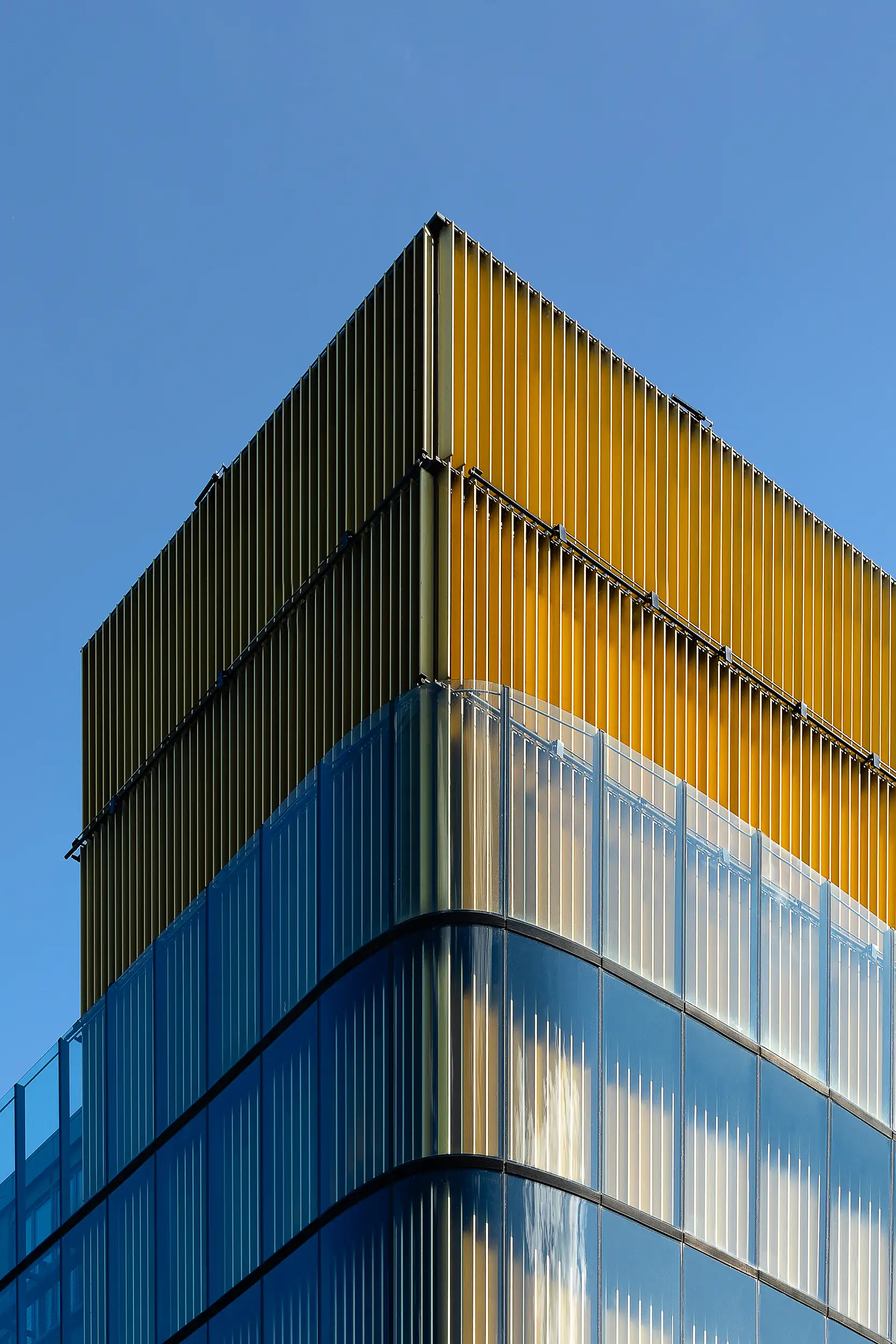 Detailaufnahme der Spitze des Palast Euro am Wenzelsplatz in Prag mit Kontrast zwischen rechteckigen Bauvolumen und weich modellierter goldener Verkleidung.