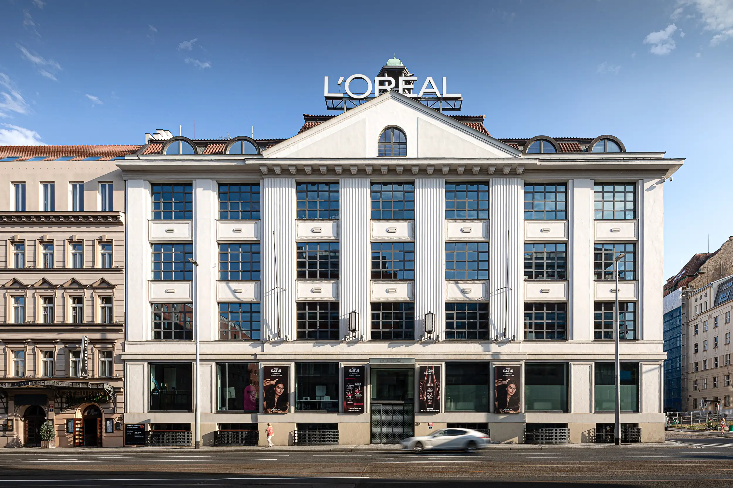 Frontal view of a section of the Krizik Palace in Prague’s Anděl district, a functionalist building housing the L’Oréal headquarters.