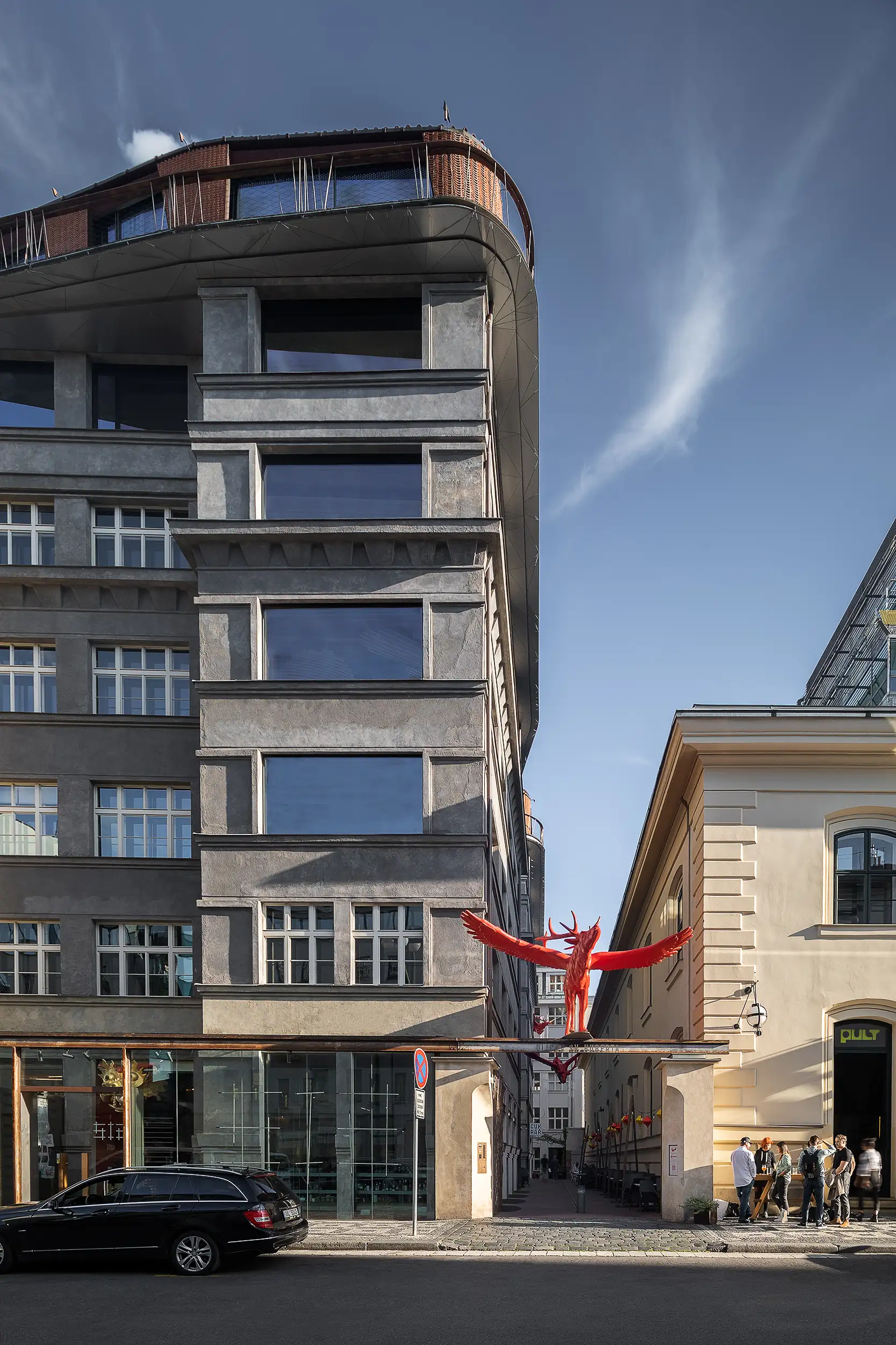Frontal-oriented, vertical golden hour architecture photography of Špork Palace in Prague captured from V Celnici Street.