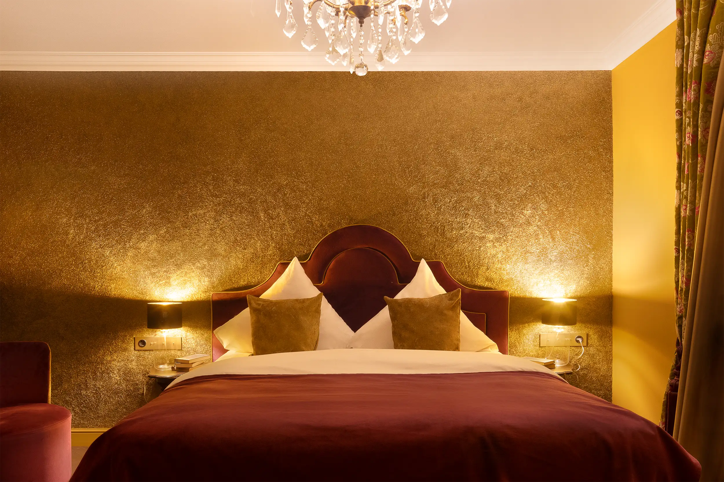 Very old fashioned luxurious castle hotel room tined in golden and dark red captured in darker mood.