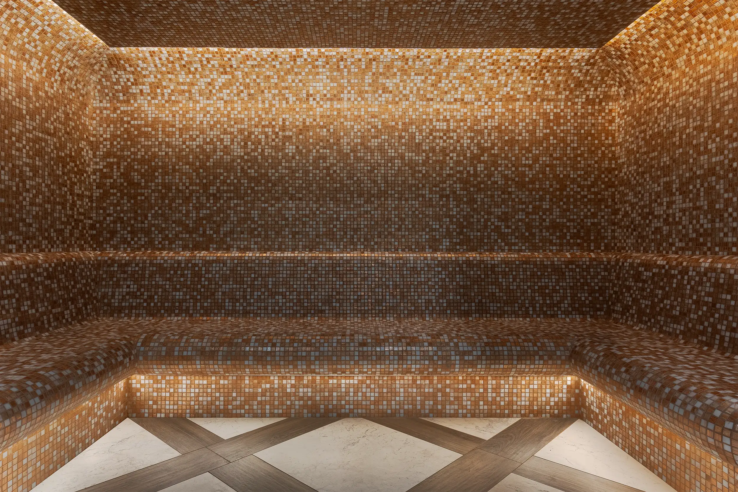 Steam sauna tiled with small mosaic tiles.
