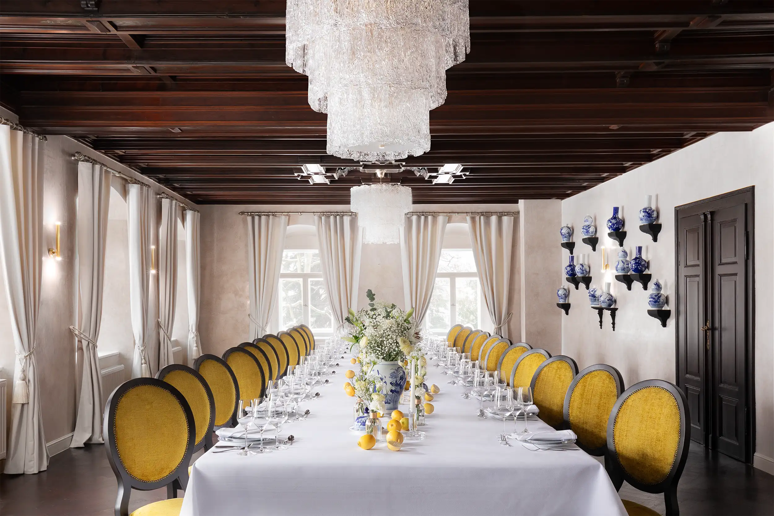 Salon von Hartig at Althörnitz Castle Hotel decorated as a wedding venue in Italian style with blue and white pottery, flowers and lemons, captured as frontal composition.