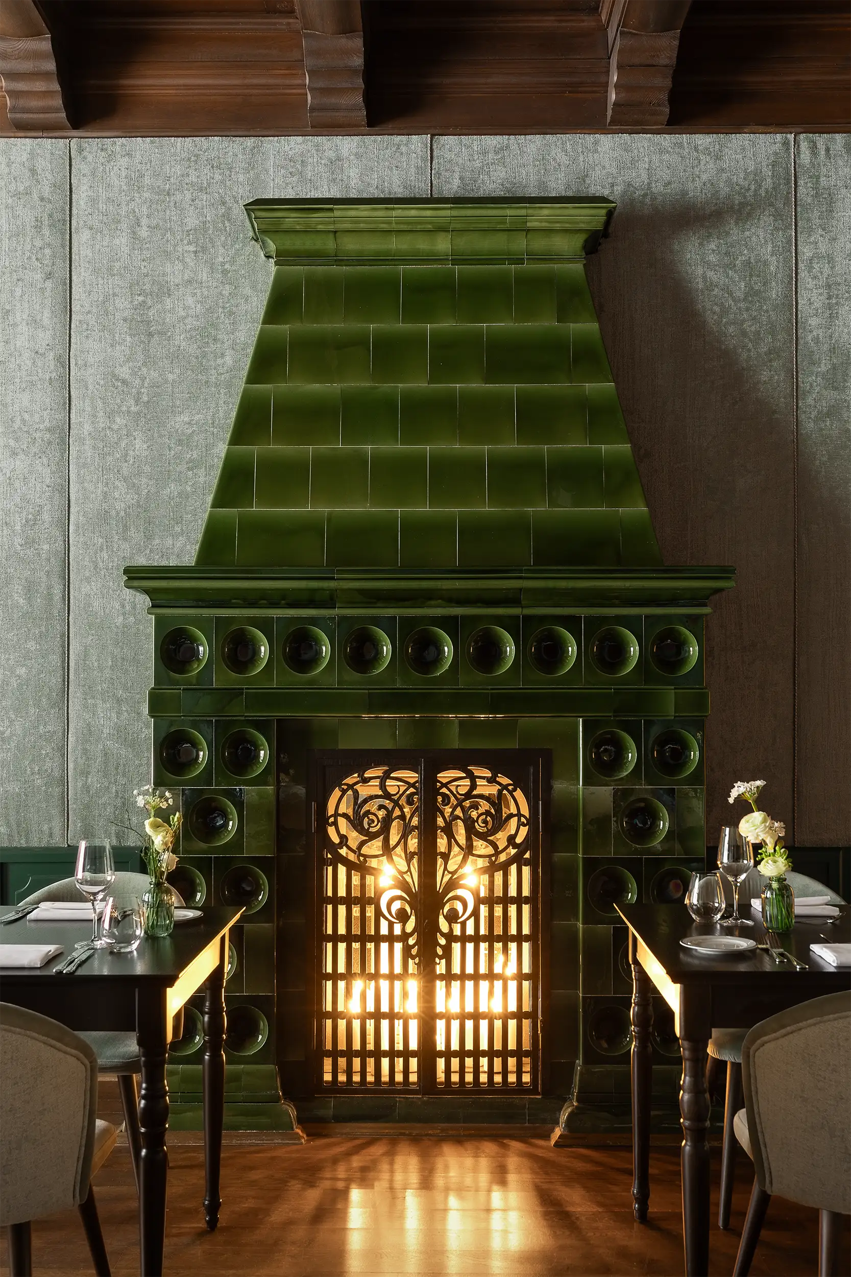 Elegant green tile fireplace in the interior of the castle hotel restaurant.