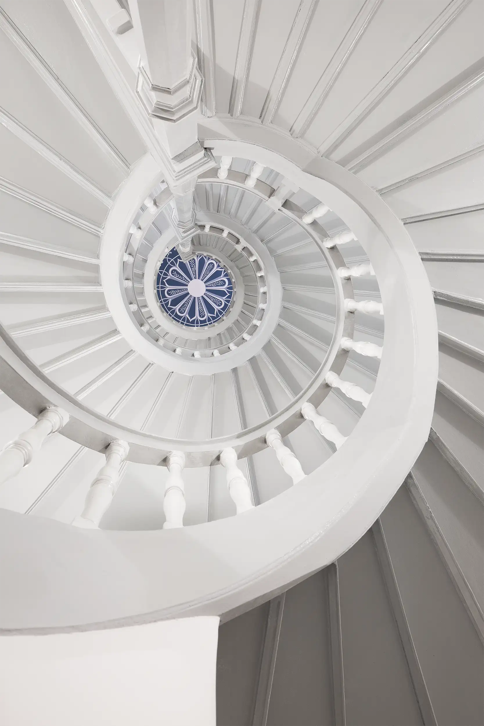 Vertical photograph of an upward view of the wooden castle spiral staircase.